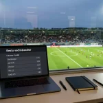 Fótboltavöllur með tölvuskjá sem sýnir veðmálalíkur og HM-2026-merki